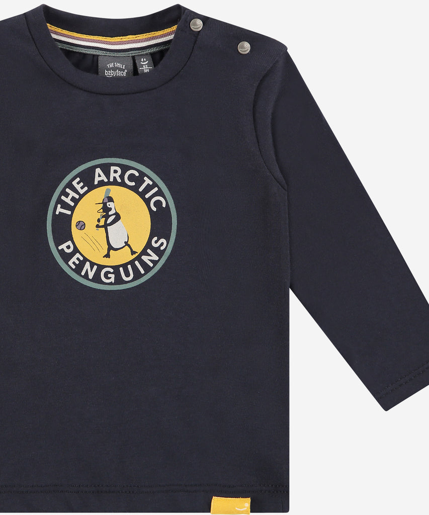 Details:  This Baby LS T-shirt is perfect for your little one. Featuring a soft fabric and long sleeves, the t-shirt keeps your baby warm. The unique Artic Penguins print gives this piece a playful touch. Perfect for casual wear on cool days. Easy opening with 2 push buttons on side of the collar. Round Neckline.  Color: Dark blue  Composition:   95% BCI cotton/5% elasthan  