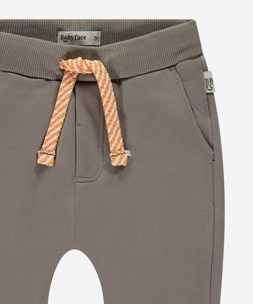 Details:  Introducing the soft Jogg Pants, designed for your little one's comfort. Crafted from a soft and durable fabric, these pants feature an elastic waistband for a secure and comfortable fit.  Ensure your child's adventures are as comfortable as can be with these Jogging Pants.  Color: Elephant grey  Composition: 95% BCI cotton/5% elasthan  