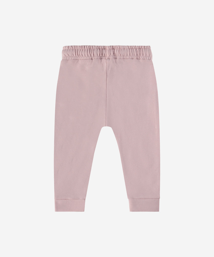 Details:  Introducing the soft Jogg Sweat Pants, designed for your little one's comfort. Crafted from a soft and durable fabric, these pants feature an elastic waistband for a secure and comfortable fit.  Ensure your child's adventures are as comfortable as can be with these Jogging Pants.  Color: Blush  Composition: 95% BCI cotton/5% elasthan  