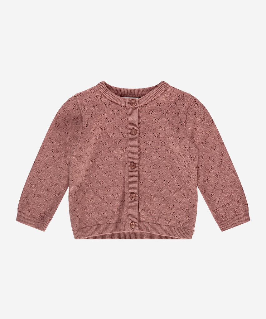 Details:  This baby knit pointelle cardigan in a soft blossom hue will keep your little one cozy and stylish. Crafted with a round neckline and convenient button closure, this cardigan is perfect for layering over any outfit. A must-have addition to any baby's wardrobe.  Color: Blossom  Composition: Summer 202