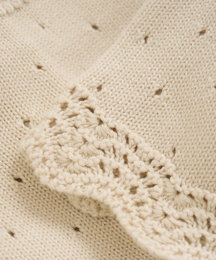 Details: This Knit Cardigan Pointelle Eggnog is a versatile addition to any wardrobe. Crafted with a knitted pointelle design and a comfortable button closure, this cardigan offers both style and convenience. Its round neckline adds a touch of elegance, making it a perfect choice for any occasion. Stay warm and stylish with this must-have piece.  Color: Eggnog  Composition:  Organic Knit 100% Cotton  