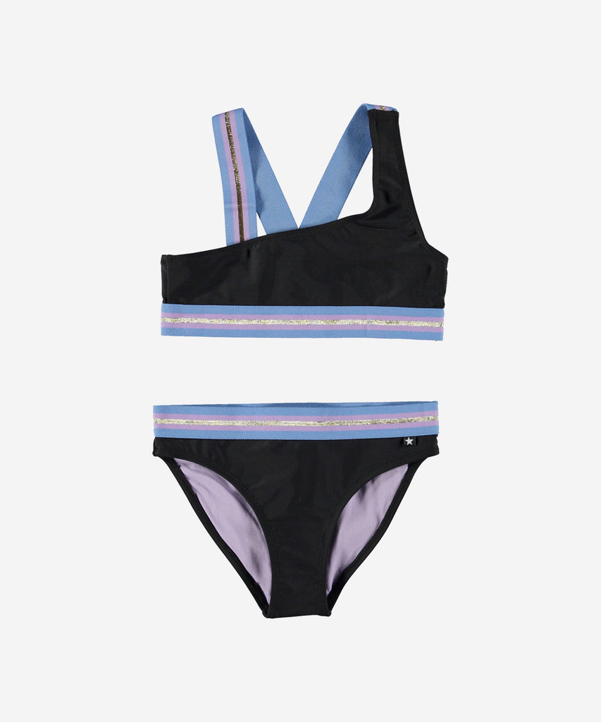 Details: Nicola is an asymmetrical, sporty bikini in black. The bikini has wide, striped straps and edging in gold, pink and blue. The straps cross on the back of the top. Molo's swimwear has 50+ UV protection.  Color: Black  Composition: 80% Nylon/ 20% Ela