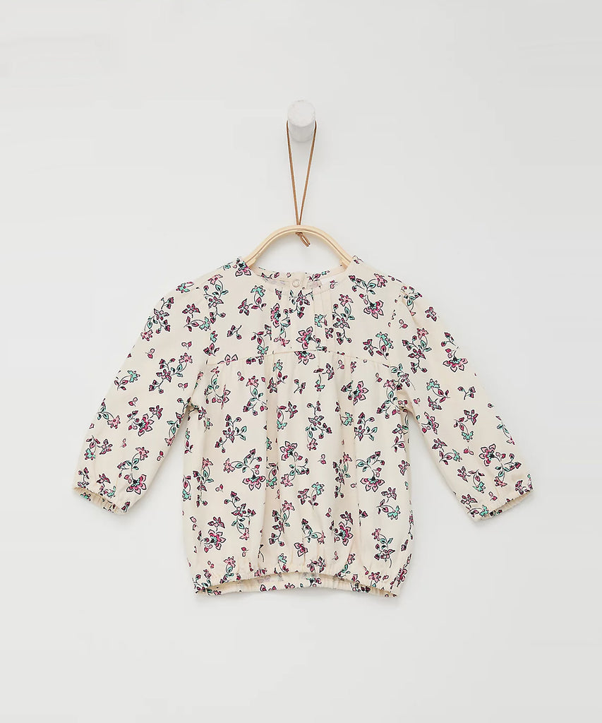 Details: Long sleeve blouse with all over print flowers. Round neckline.  Color: Cream  Composition: 100%CV   
