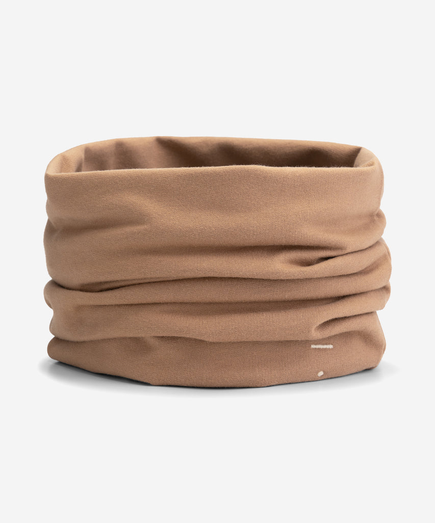 Details: A cowl scarf made from soft organic cotton fleece and has baby lock stitched edges. Logo is stitched on the bottom right side of the scarf.  Color: Biscuit  Composition: 100% organic cotton fleece  Made in Portugal 