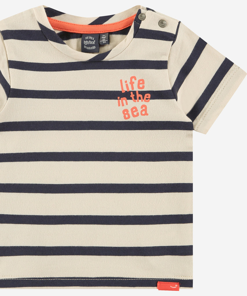 Details: Short sleeve t-shirt with stripes and text 'life at the sea'. Easy opening with 2 push buttons on side of the collar. Round Neckline.  Color: Chalk  Composition:  95% cotton/5% elasthan  