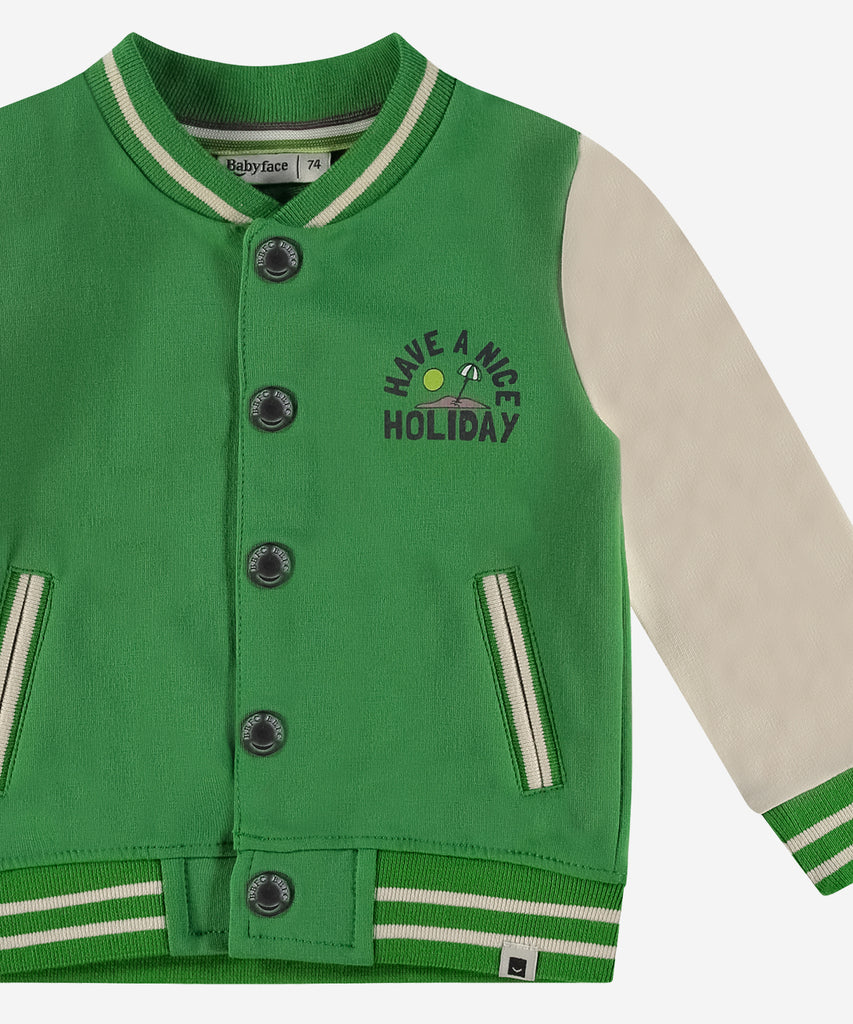 Details: This baby bomber cardigan combines college style with practicality, featuring pockets and ribbed arm cuffs and waistband for a comfortable and classic look. Perfect for the holiday season, it adds a pop of vibrant grass green to your little one's wardrobe.  Color: Grass green cream  Composition: 95% BCI cotton/5% elasthan  