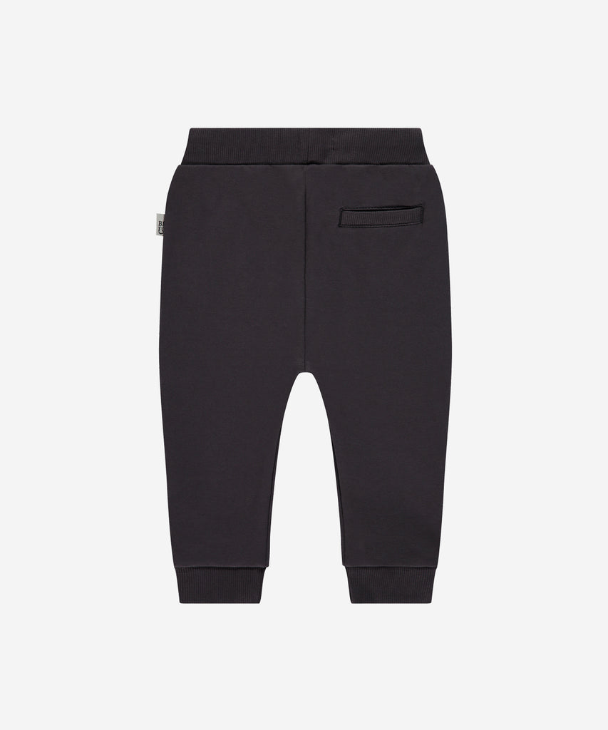 Details:  Introducing the soft Jogg Pants, designed for your little one's comfort. Crafted from a soft and durable fabric, these pants feature an elastic waistband for a secure and comfortable fit.  Ensure your child's adventures are as comfortable as can be with these Jogging Pants.  Color: Dark grey  Composition: 95% BCI cotton/5% elasthan  