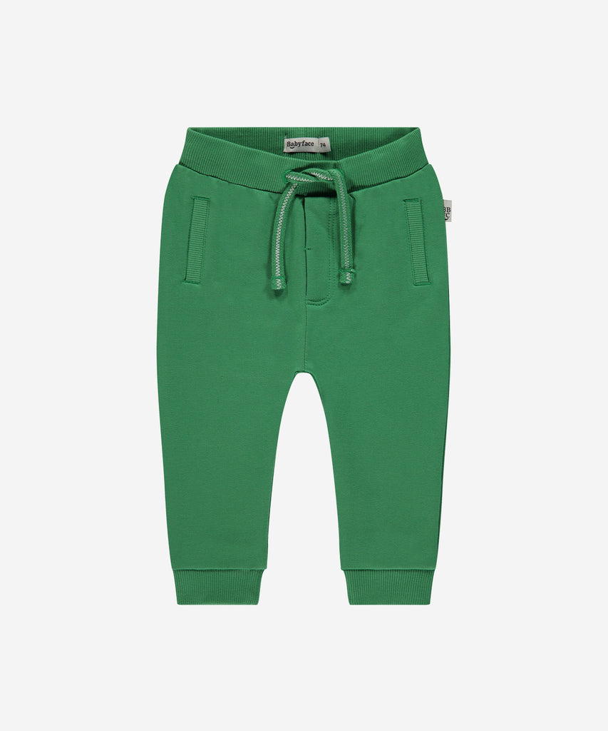 Details:  Introducing the soft Jogg Pants, designed for your little one's comfort. Crafted from a soft and durable fabric, these pants feature an elastic waistband for a secure and comfortable fit.  Ensure your child's adventures are as comfortable as can be with these Jogging Pants.  Color: Grass green  Composition: 95% BCI cotton/5% elasthan  