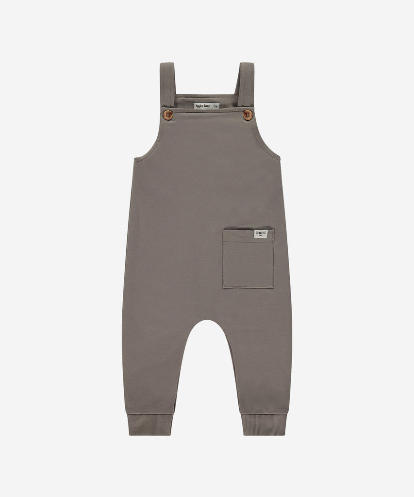 Details: Expertly crafted in a beautiful elephant grey, this Baby Dungaree is the perfect addition to your little one's wardrobe. The push buttons make it easy to open and close, while the pocket adds a stylish touch. Made with comfort and convenience in mind, it's a must-have for any stylish baby.  Color: Grey  Composition : 95% cotton/5% elasthan  
