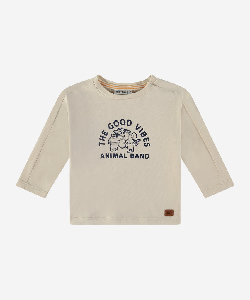 Details:  This baby long sleeve t-shirt features a round neckline and an easy opening with 2 push buttons for added convenience. With its soft cream color and cute animal band design, it's perfect for spreading good vibes!  Color: Cream  Composition:   95% BCI cotton/5% elasthan  