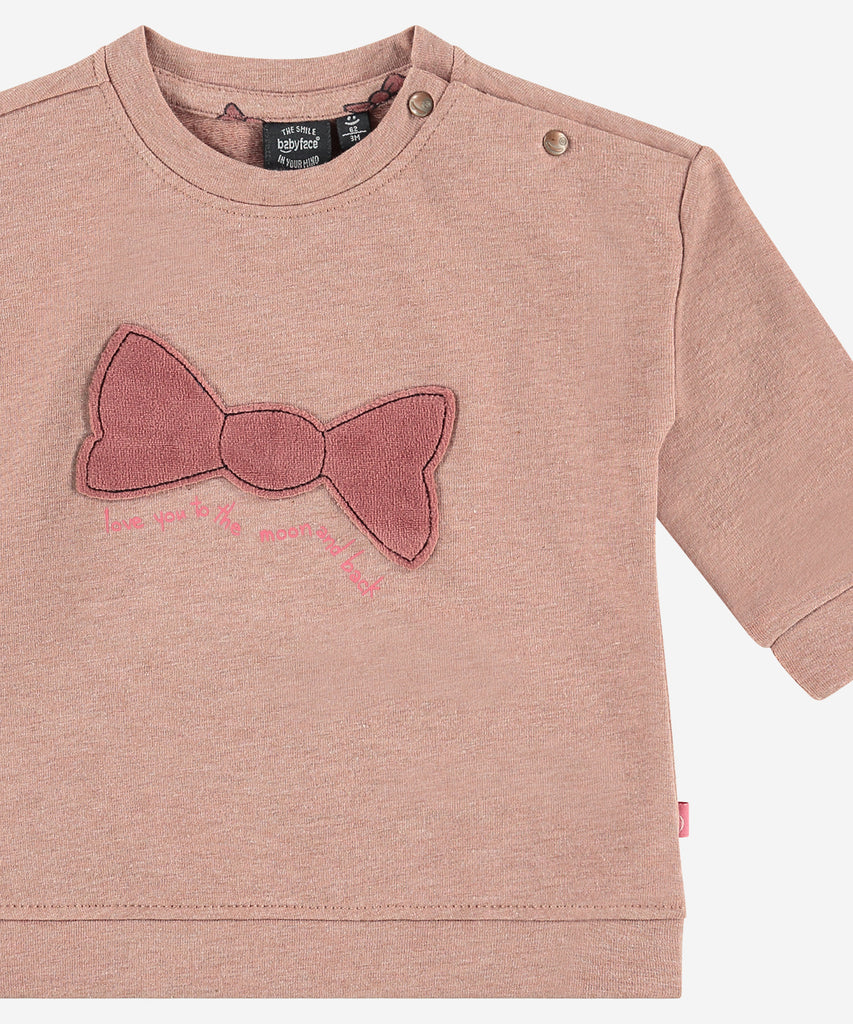 Details: This Baby Sweatshirt is perfect for keeping your little one cozy and comfortable. Crafted from soft fabric, it features a round neckline, bow on the front, and ribbed waistband and armcuffs for an extra snug fit. Perfect for helping your baby stay warm and stylish. Easy opening with 2 buttons on the side.  Color: Blush melee  Composition:   95% BCI cotton/5% elasthan  