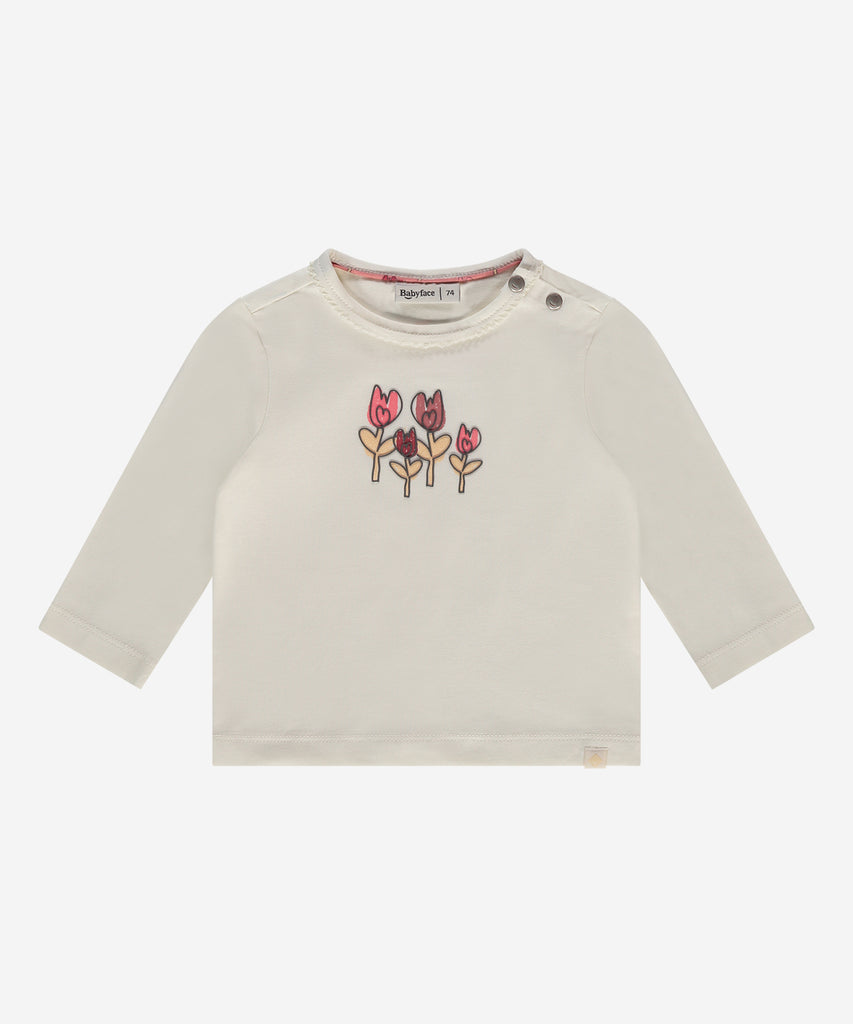 Details:  This baby long sleeve t-shirt features a round neckline and an easy opening with 2 push buttons on the side for added convenience. With its soft ivory color and cute tulip design, it's perfect for spreading good vibes!  Color: Ivory  Composition:   95% BCI cotton/5% elasthan  