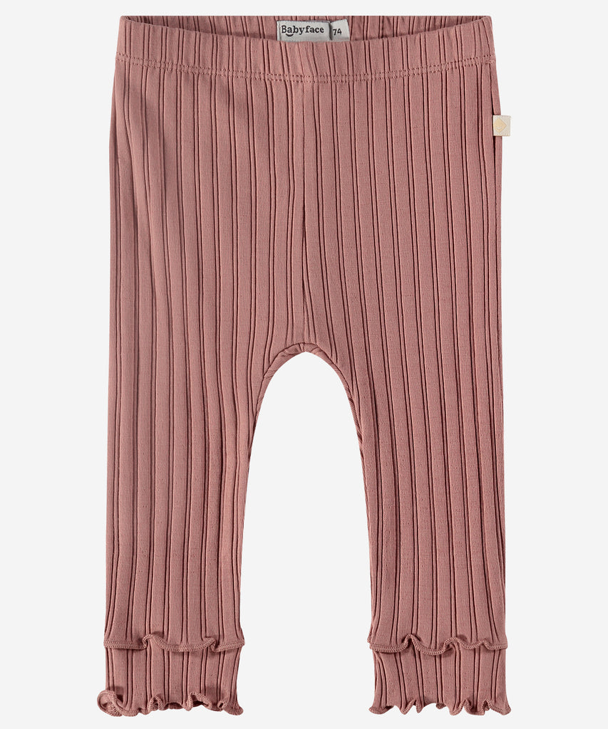 Details: "Made with soft ribbed fabric, our Baby Rib Leggings Blossom provide comfort and flexibility for your little one. The elastic waistband ensures a secure fit, while the frill detailing adds a playful touch. Perfect for everyday wear or special occasions."   Color: Blossom  Composition: 95% BCI cotton/5% elasthan  
