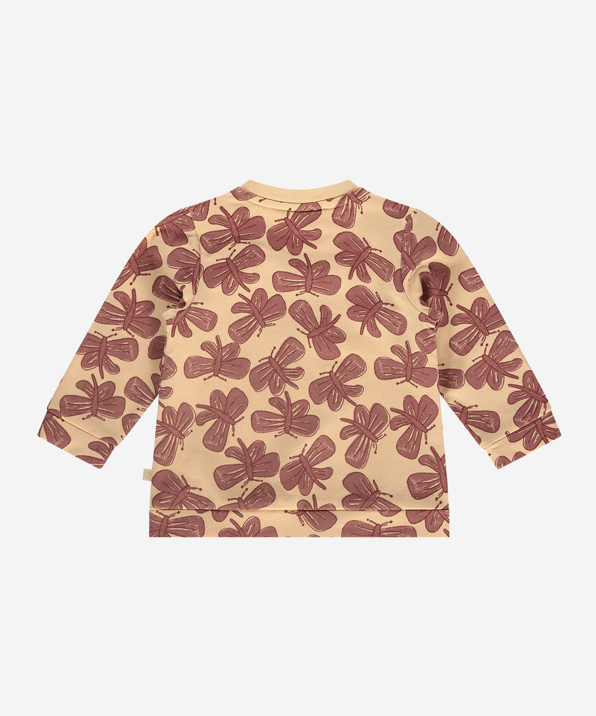 Details:  This fashionable baby sweatshirt is made with an all over print butterflies, a round neckline, ribbed arm cuffs, and push buttons on the side for easy opening. Perfect for any little one, this sweatshirt provides both comfort and style.  Color: Vanilla  Composition:  95% BCI cotton/5% elasthan  