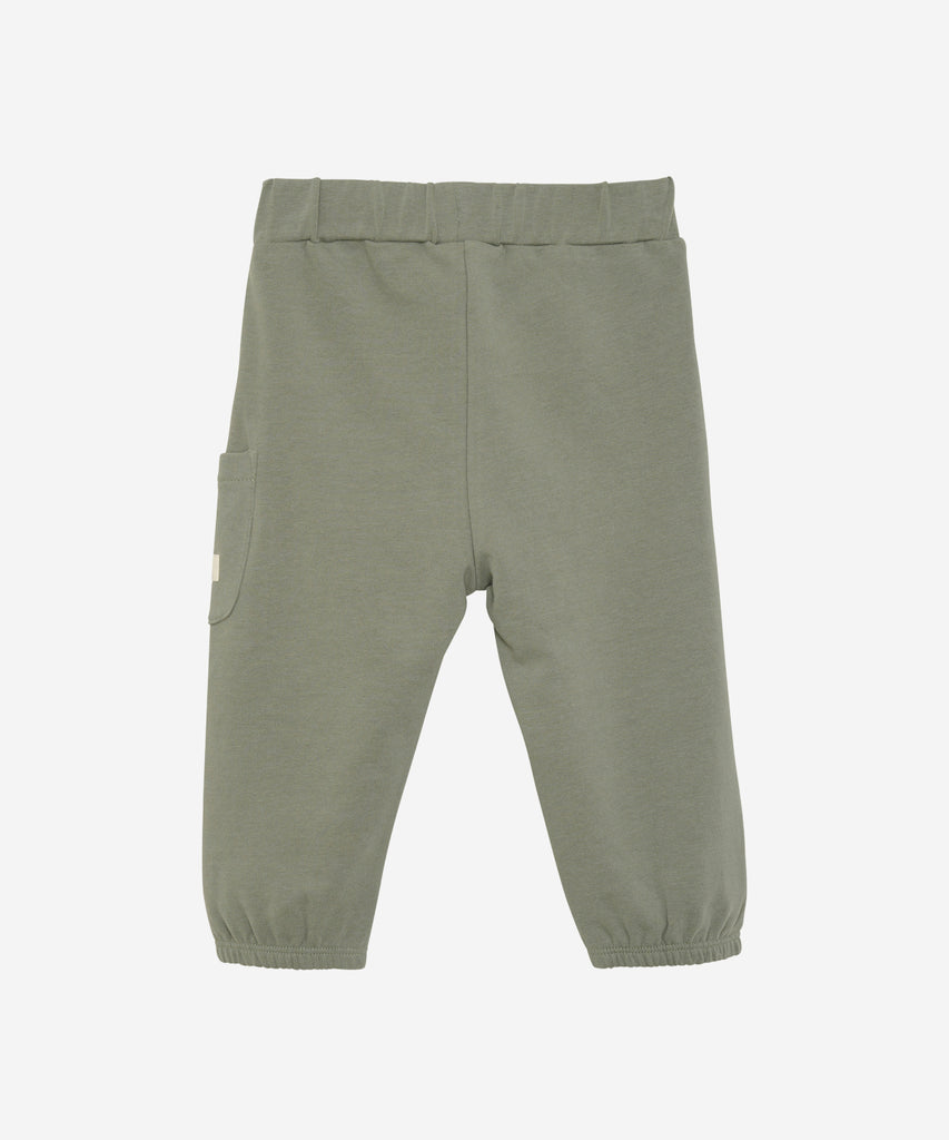 Details:Stay comfortable and stylish with our Baby Button Pocket Jogg Pants in Sea Spray. These pants feature an elastic waistband for a snug fit and convenient button pockets for storing small items. Perfect for active babies on the go!  Color: Sea spray  Composition:  Organic Sweat 95% Cotton/ 5% Elastane  
