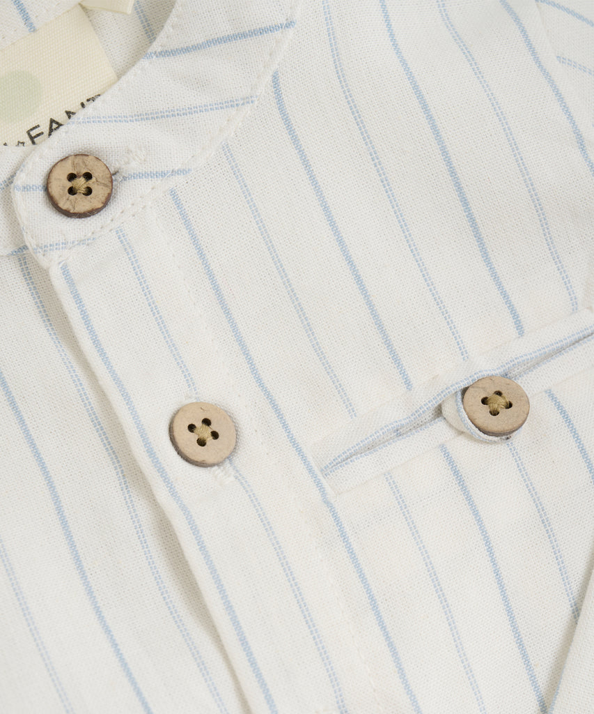 Details: This baby woven mao shirt in eggnog features a convenient pocket, classic stripes, and easy button closure. Made with soft and durable fabric, it provides comfort and style for your little one. Perfect for any occasion, this shirt is a must-have for any stylish baby's wardrobe.   Color: Eggnog  Composition: Organic Woven Yarndyed 100% Cott