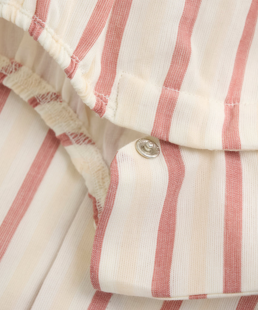 Details: Expertly designed with summer in mind, our Woven Baby Summer Romper is perfect for keeping your little one comfortable and stylish. Featuring convenient push buttons for easy dressing, this romper is made with a trendy striped design. Make dressing a breeze for both you and your baby with our must-have summer romper.  Color: Eggnog  Composition:  Organic Woven Yarndyed 100% Cotton  