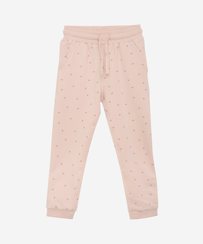 Details: The Jogg Pants Berry Dots Peach Whip are expertly designed for comfort and style. The elastic waistband ensures a perfect fit, while the berry dots add a touch of playfulness. With convenient pockets, these jogging pants are perfect for everyday wear.  Color: Peach whip  Composition:  Organic Sweat 95% Cotton/ 5% Elastan