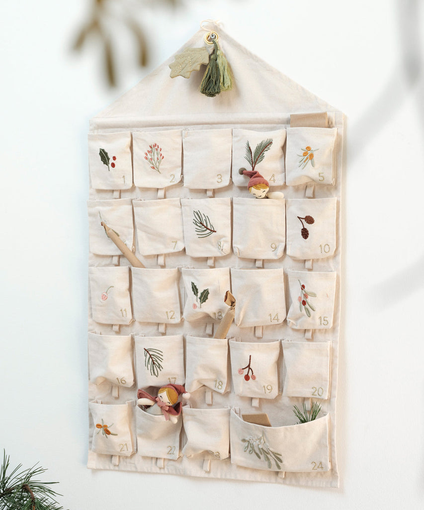 Fabelab  Fabelab's decorative Wall Calendar, is decorated with gorgeous embroidered details of yule greens, which are inspired by the season's branches, leaves and berries and has a sophisticated and romantic look. This Wall Calendar has 24 pockets with small loops attached to fill with little surprises that make every day special, as we count down till Christmas.   Size: 50 x 82cm  Material: 100% Organic cotton (Polyester Embroidery thread)  Designed in Denmark 