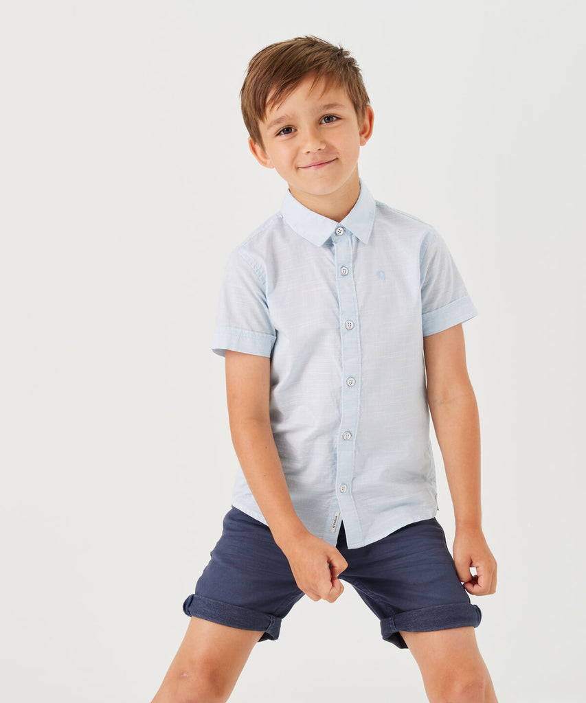 <strong data-mce-fragment="1">Details:</strong>&nbsp; This woven kids shirt in light blue offers a classic and stylish look for any occasion. Made with high-quality, durable fabric, it features a button closure for convenience and comfort. Perfect for dressing up or down, this shirt is a must-have for your little one's wardrobe.&nbsp;<br><strong>Color:</strong> &nbsp;Light blue&nbsp;<br><strong data-mce-fragment="1">Composition:</strong>&nbsp; 100% Cotton &nbsp;