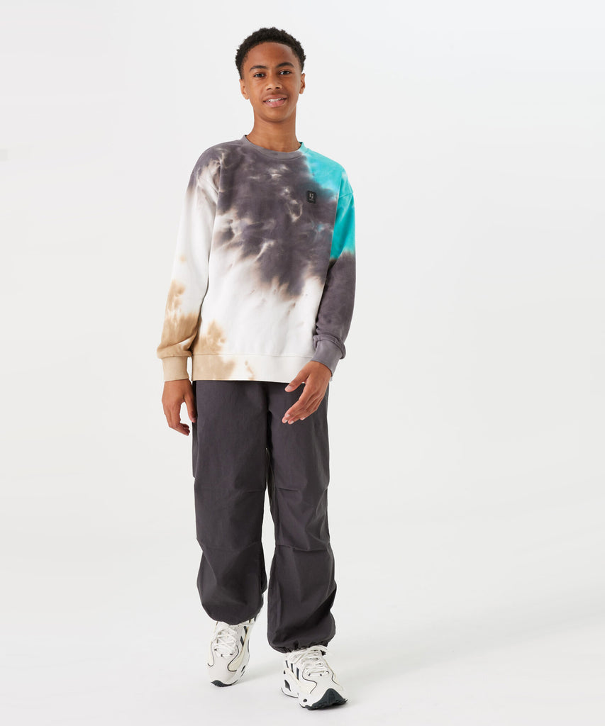 Details:  Stay on trend with our Sweatshirt Spring Tie Dye in Off White, grey and turkis. Made with a round neckline and ribbed arm cuffs and waistband, this sweatshirt offers both style and comfort. The unique tie dye pattern adds a pop of color to your wardrobe. Perfect for casual wear or a statement piece.  Color: Off white  Composition:  80% Cotton, 20% Polyester  