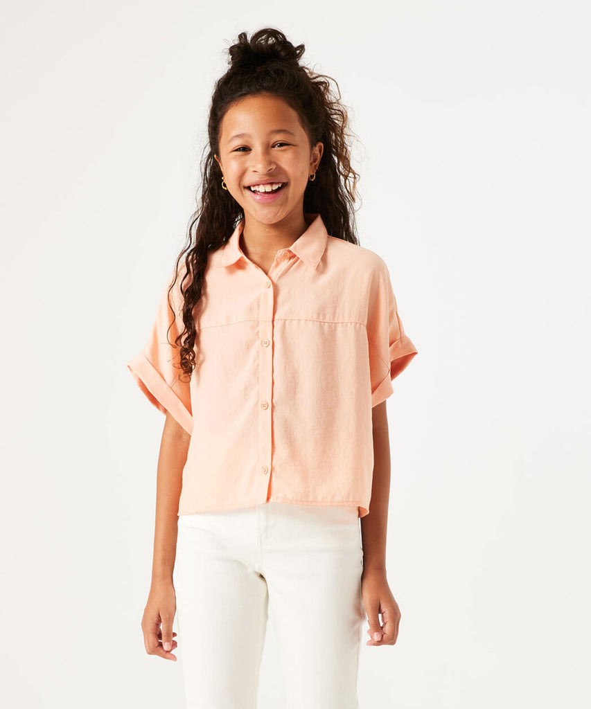 vDetails: This Wide Fit Blouse in Peach Bloom offers a comfortable and stylish fit with its wide fit and short sleeves. The button closure adds a touch of sophistication. Perfect for any occasion, this blouse is a versatile addition to your wardrobe.  Color: Peach bloom  Composition:  100% Polyester  