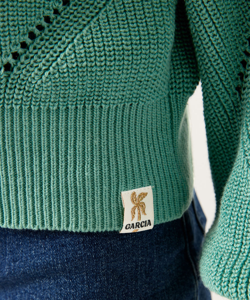 Details: ﻿"Expertly crafted with a knitted rib design, this Beryl Green pullover exudes effortless style. The round neckline adds a touch of elegance, while the ribbed arm cuffs and waistband provide a comfortable fit. Elevate your wardrobe with this versatile and on-trend piece."   Color: Beryl green  Composition:  50% Cotton, 50% Polyester   