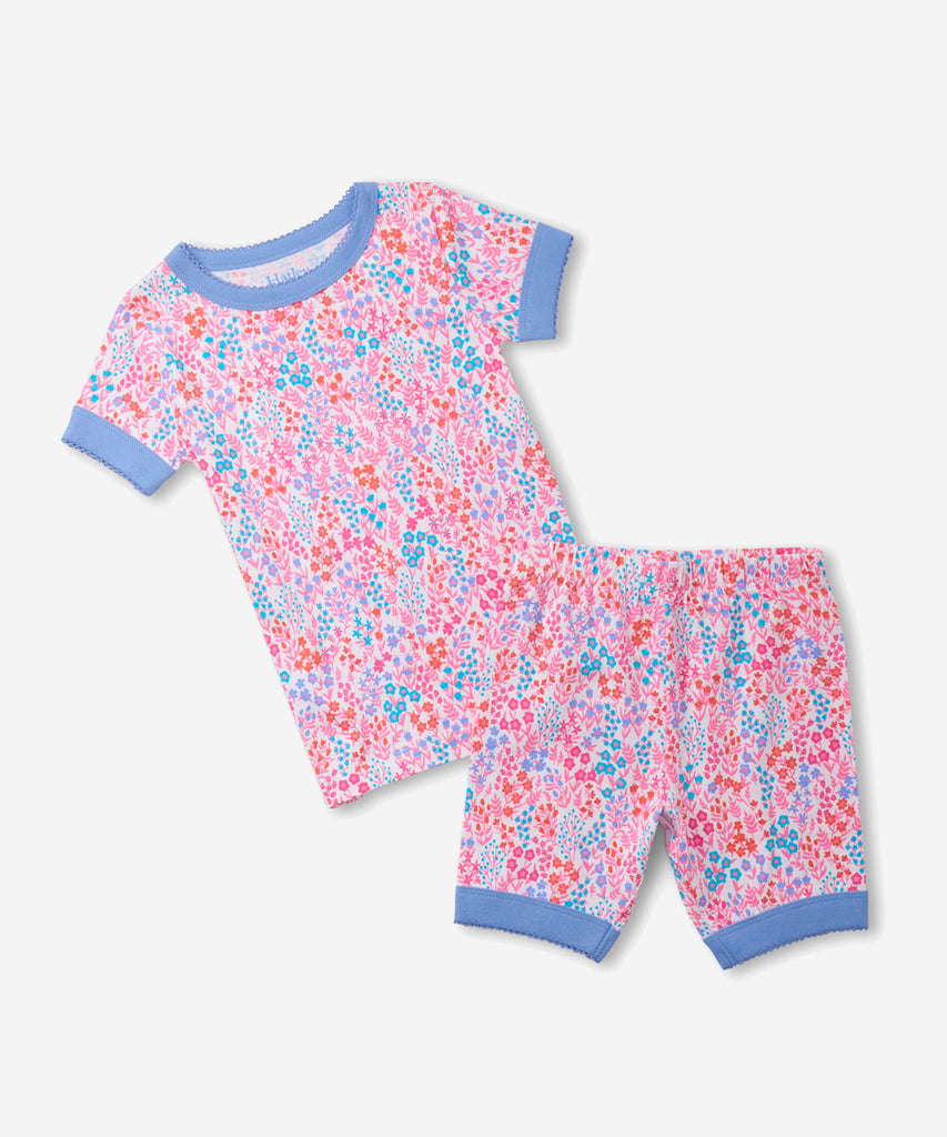 Details:  Nothing will keep them cooler on those warm summer nights than this cozy Pyjama set! Featuring short sleeves, a short pant, all over print doodle and crafted from organic cotton, these are sure to make summer sleep a breeze.  Color: Pink  Composition:  100% Organic Cotton  