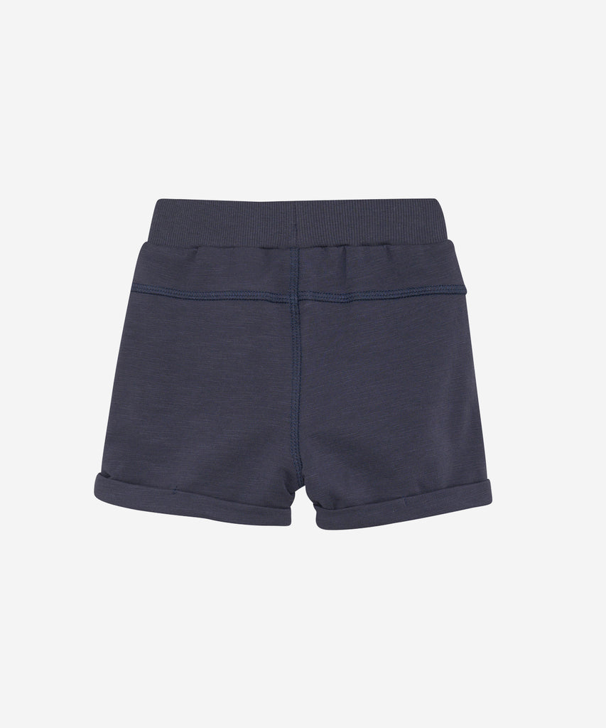 Details: These baby sweat shorts are both stylish and functional. Designed in a trendy blue night color, they feature convenient pockets and an elastic waistband for easy wear. Perfect for active little ones on the go.  Color: Blue night  Composition: Organic Sweat-slub Yarn 95% Cotton/ 5% Elastane  