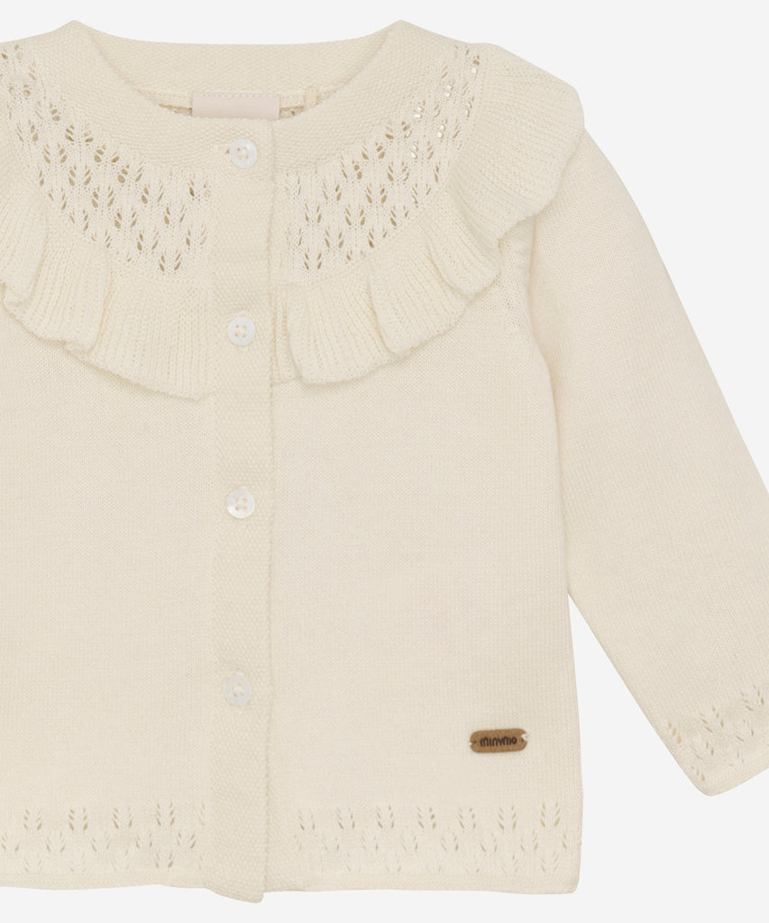 Details: This expertly-crafted Baby Knit Cardigan is made with a soft knitted fabric, perfect for your little one's delicate skin. The button closure adds convenience and security, while the classic design allows for easy pairing with any outfit. Keep your baby cozy and stylish with this essential piece. Round Neckline.  Color: Pristine  Composition:  Organic Knit 100% Cotton  
