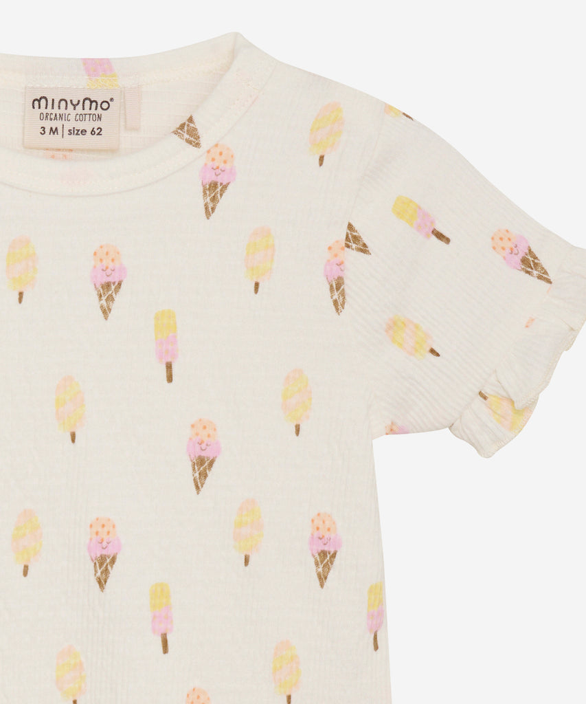 Details:  This short sleeve baby t-shirt features a fun and playful all over print of different types of ice cream. The round neckline ensures a comfortable fit for your little one. Perfect for adding a touch of sweetness to their wardrobe.   Color: Pristine  Composition: Organic Single Jersey 97% Cotton/ 3% Elastane 
