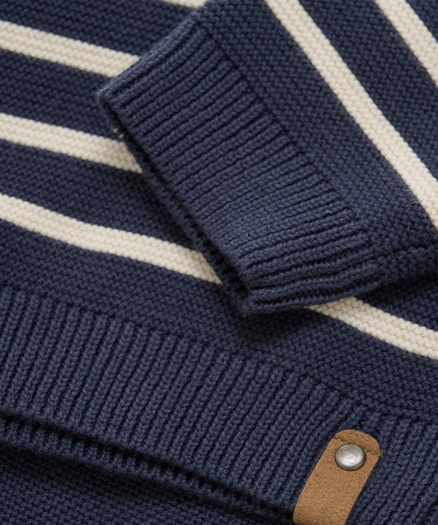 Details: Crafted with soft, knitted cotton, this pullover offers both comfort and style. The marine stripes add a classic touch, while the ribbed arm cuffs and waistband provide a snug fit. The round neckline completes the look, making this piece a must-have for any wardrobe.  Color: Blue nights  Composition:  Organic Knit 100% Cotton  