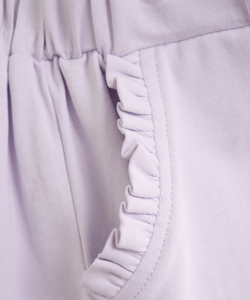 <strong>Details:</strong>&nbsp; These soft frill shorts in orchid petal color are designed with comfort in mind. The elastic waistband provides a perfect fit, and the pockets add functionality to the stylish design. Expertly crafted with soft fabric, these shorts are sure to be a favorite for any summer outing.&nbsp;<br><strong>Color:</strong> Orchid petal&nbsp;<br><span><strong>Composition:</strong>&nbsp;Organic Single Jersey 95% Cotton/ 5% Elastane&nbsp;</span>