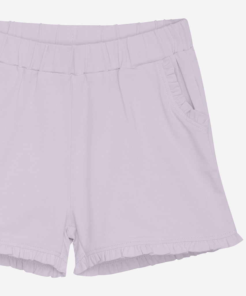 <strong>Details:</strong>&nbsp; These soft frill shorts in orchid petal color are designed with comfort in mind. The elastic waistband provides a perfect fit, and the pockets add functionality to the stylish design. Expertly crafted with soft fabric, these shorts are sure to be a favorite for any summer outing.&nbsp;<br><strong>Color:</strong> Orchid petal&nbsp;<br><span><strong>Composition:</strong>&nbsp;Organic Single Jersey 95% Cotton/ 5% Elastane&nbsp;</span>