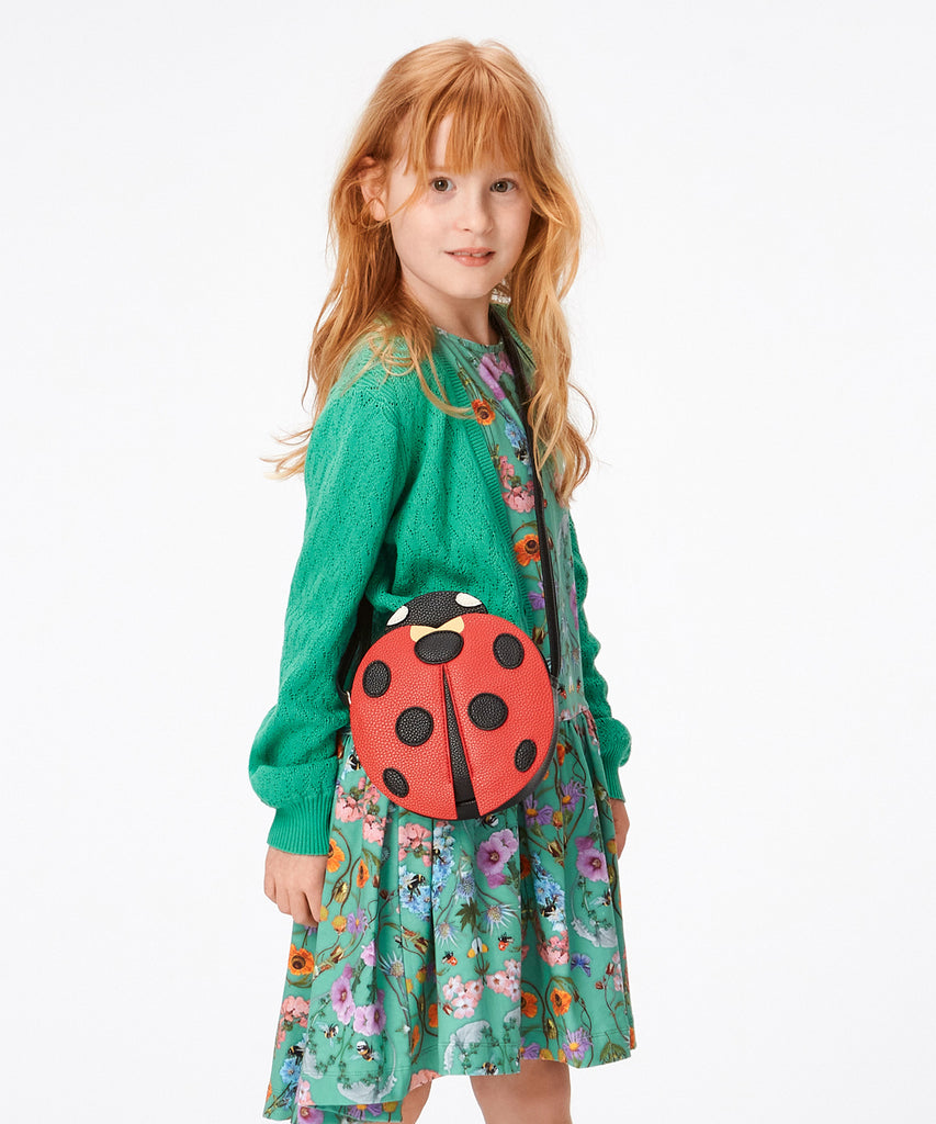 Details:  Our Ladybug Cross Body bag is the perfect companion for any adventure! This bag features an adorable ladybug design and zip closure to make sure your items are safe and secure. With this stylish bag, you're sure to be a hit no matter where your day takes you!  Color: Black red  Composition:  100% Polyurethane 