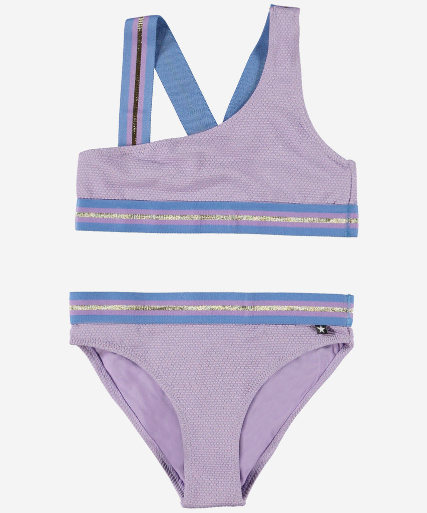 Details: Nicola is an asymmetrical, sporty bikini in purple viola. The bikini has wide, striped straps and edging in gold and bordeaux. The straps cross on the back of the top. Molo's swimwear has 50+ UV protection.  Color: Viola  Composition: 87% Nylon/ 7% Metallic yarn/ 6% Elastane 