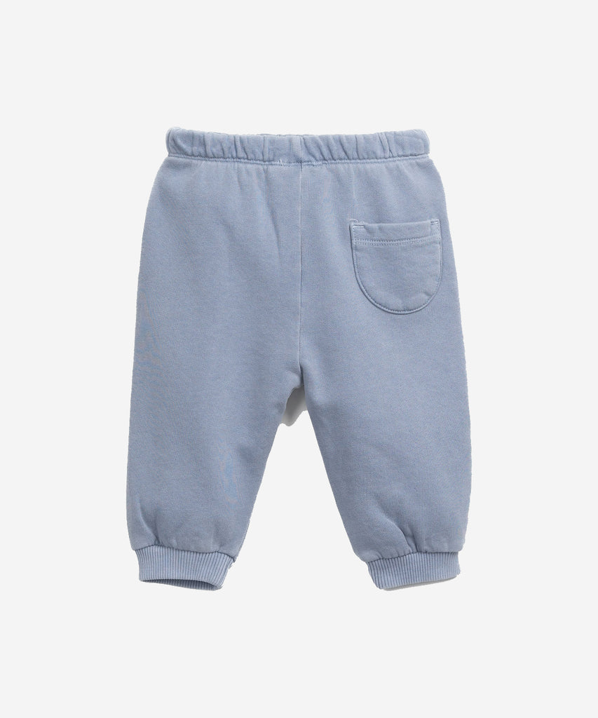 Details: These jersey-stitch trouser are made of a mixture of organic cotton and cotton, Sea colour. This model has an elastic waist and decorative drawstring, front pockets and elastic hems.  Colour: Sea blue  Composition:  70.0% Organic Cotton,30.0% Cotton  