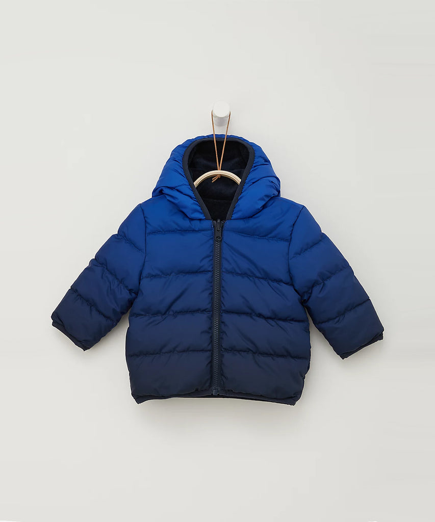 Details:  Ombre blue reversible winter jacket with zip closure. Pockets and water repellent.  Color: Ombre blue  Composition: 100% PES 
