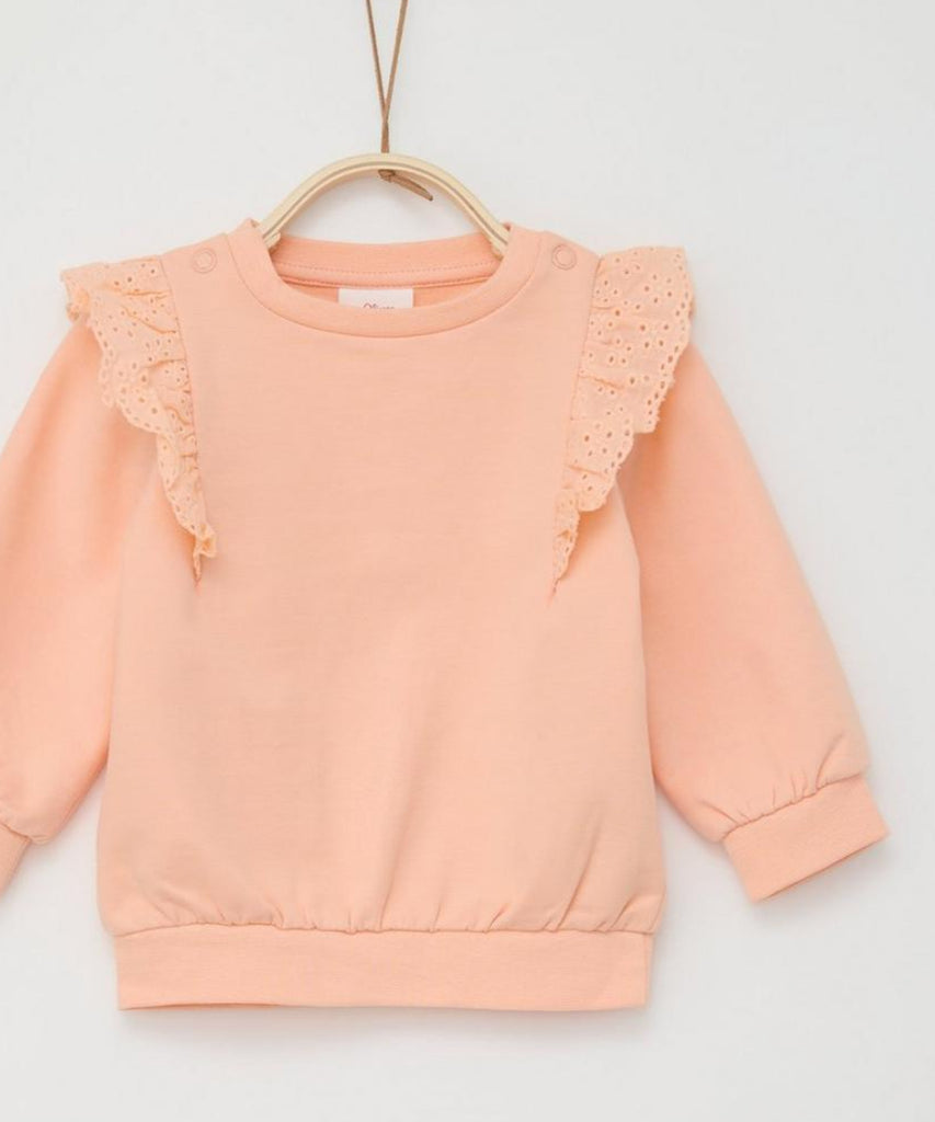 Details:  Expertly designed for your little one, our Baby Frill Sweatshirt is the perfect addition to their wardrobe. The apricot orange color adds a pop of brightness, while the frills on the sweater provide a touch of elegance. With a round neckline and ribbed arm cuffs and waistband, this sweatshirt ensures a comfortable and stylish fit.  Color: Apricot  Composition: 095%CO 005%EL   