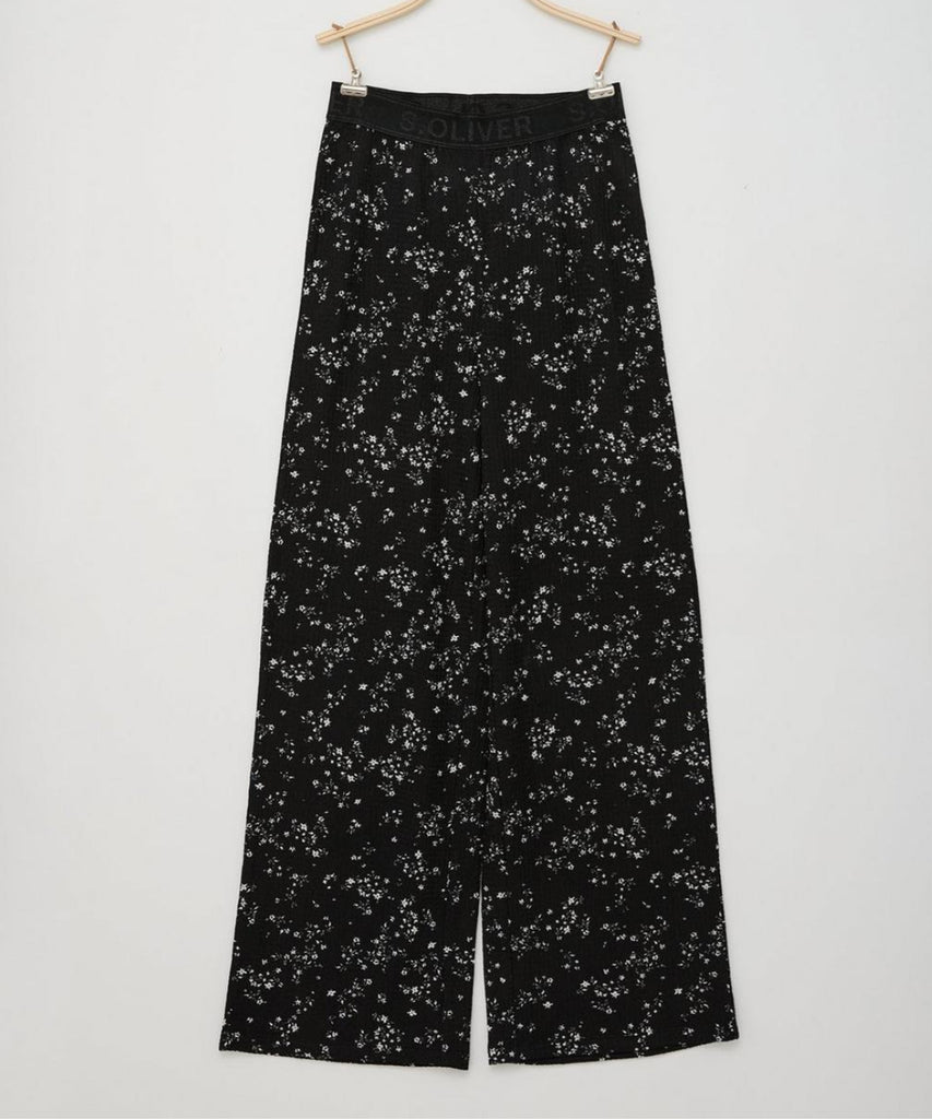Details: These black wide culotte pants feature a beautiful all-over flower print, making them a stylish addition to any wardrobe. The elastic waistband ensures a comfortable and adjustable fit, while the wide culotte design offers a trendy and versatile look. Perfect for any occasion, these pants are a must-have for any fashion-forward young girl.   Color: Black  Composition: 098%PES 002%EL