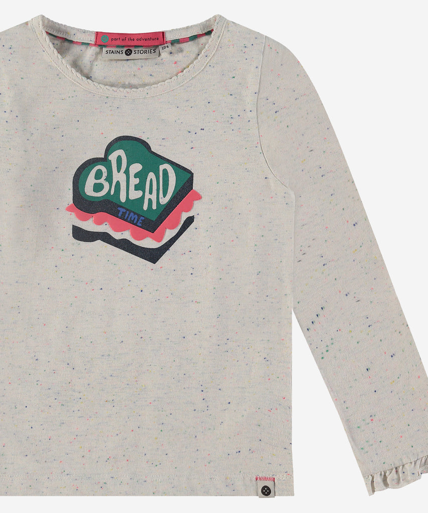 Details: Introducing our LS T-Shirt Bread Speckled Off White, a must-have for trendy fashion enthusiasts. With its long sleeves and speckled white design, this shirt is perfect for any occasion. The unique bread print on the front adds a touch of fun and whimsy to your wardrobe. Stay stylish with this one-of-a-kind shirt. Up to size 92, easy opening with 2 push buttons on the side of the collar. Round Neckline.   Color: Off white  Composition:80% BCI cotton/20% polyester  