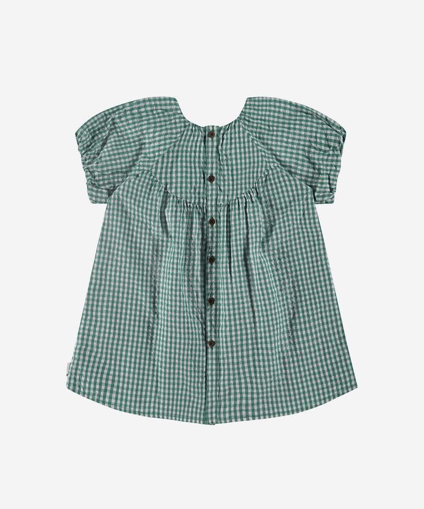 Details: Crafted from high-quality woven fabric, this Vichy dress features a classic round neckline and a stunning emerald green color. The button closure on the back adds a touch of elegance to this timeless piece. Perfect for any occasion, this dress is a must-have addition to your wardrobe.  Color: Emerald  Composition: 100% cotton 