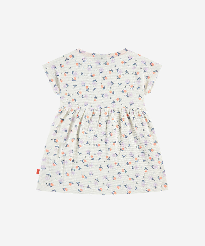 Details: Short sleeve dress with all over print flowers. Button closure on the front. Round Neckline.  Color: Ivory  Composition:   96% cotton/3% polyester/1% elasthan  