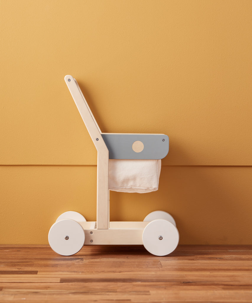 Kid's Concept  A wooden shopping trolley with 100% cotton storage. A great role play toy that encourages mobility and is the perfect addition to any child’s play shop. Use both the upper basket and lower tray to collect groceries as you wander the isles!  Age: 2y+  Size: 36 x 28.5 x 50cm