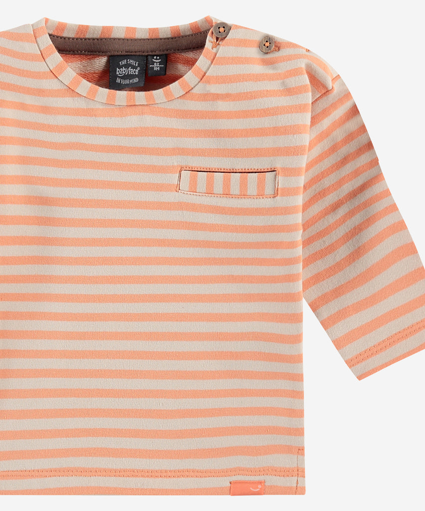 Details: Sweatshirt with stripes and a pocket on the front. Easy opening with 2 buttons on side of the collar. Round Neckline.  Color: neon orange  Composition:  95% cotton/5% elasthan  