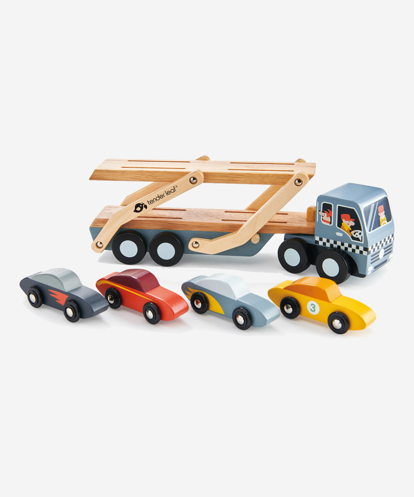 Tender Leaf®  A solid wood transporter with detachable carrier, 4 stylish super cars with metal wheels and a lift down boarding ramp. Check out the little dog in the front cabin!    Includes: 4 stylish cars with metal wheels, transporter truck with detachable carrier.  Age: 3 Years and older  Size: 51 x 8 x 13cm