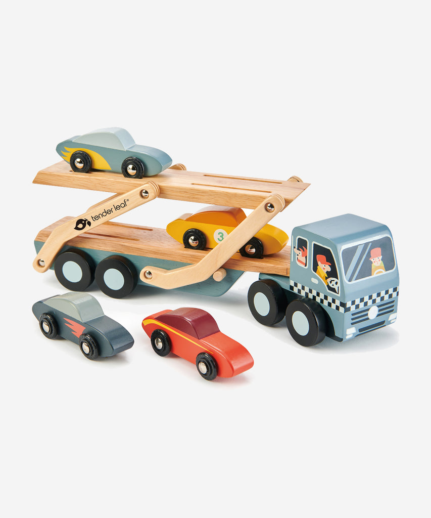 Tender Leaf®  A solid wood transporter with detachable carrier, 4 stylish super cars with metal wheels and a lift down boarding ramp. Check out the little dog in the front cabin!    Includes: 4 stylish cars with metal wheels, transporter truck with detachable carrier.  Age: 3 Years and older  Size: 51 x 8 x 13cm