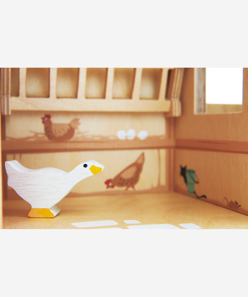 Tender Leaf®  Made throughout from top quality plywood, this farm has been designed to be open and accessible for little hands. It features a barn with barn doors and a feeding trough, 2 stables with opening doors, a ladder leading to hay loft, a pulley system with a magnetic end to lift the hay bales, a cowshed with feeding compartments, four fences, a stile, three hay bales, 2 geese, 2 horses, a grain trough, an animal feeding trough, a beehive and 6 logs. 