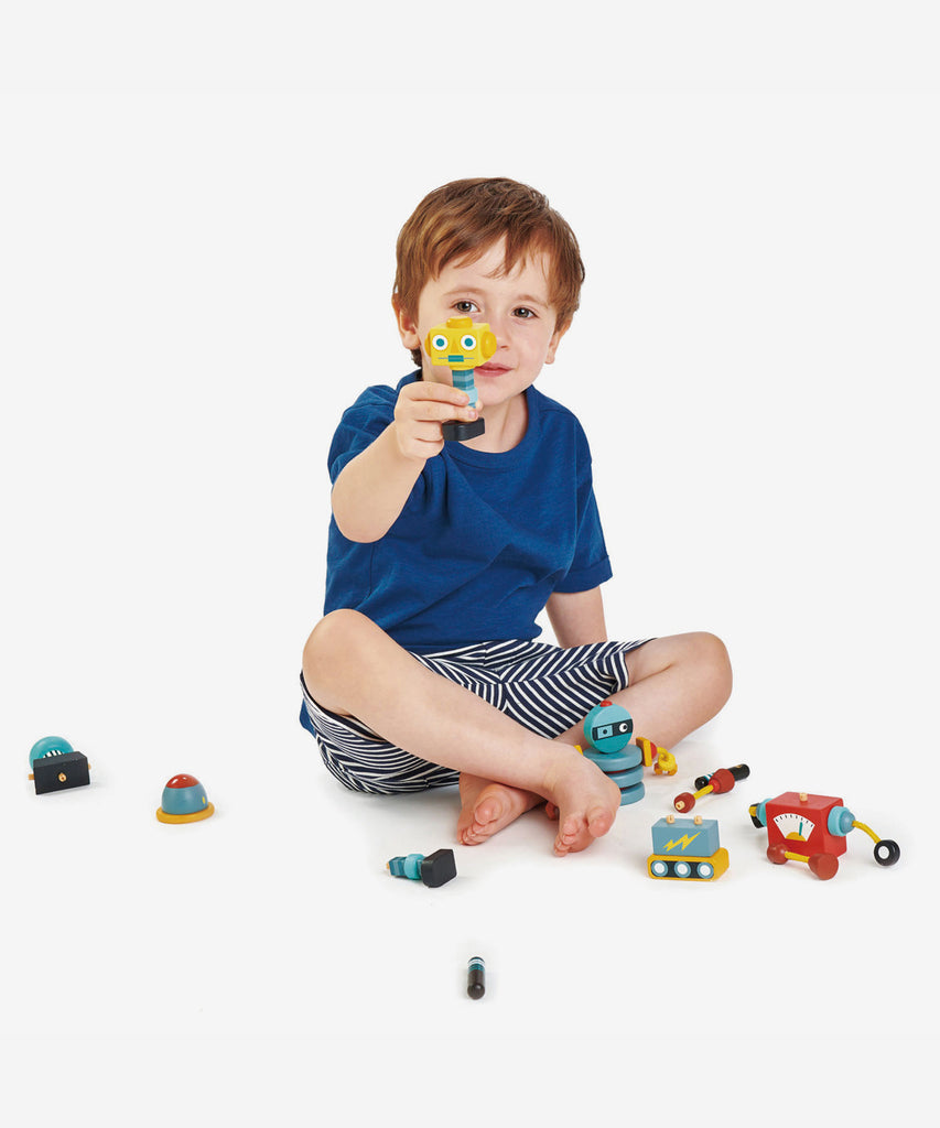 Tender Leaf®  3 brightly colored and retro style robots made from solid rubber wood that all come apart so that they can be reconstructed in a variety of ways for creative play.   Age: 3 Years and older  Size: Box 12.5 x 32 x 13cm Composition: sustainable and/or recycled wood 